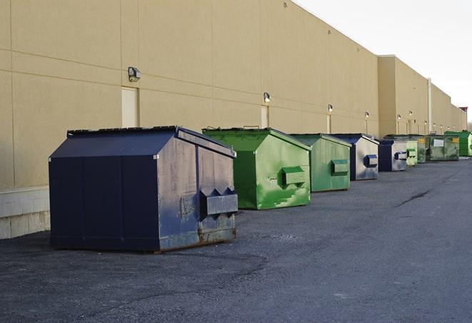 tilted front-load dumpsters being emptied by waste management workers in Addison PA